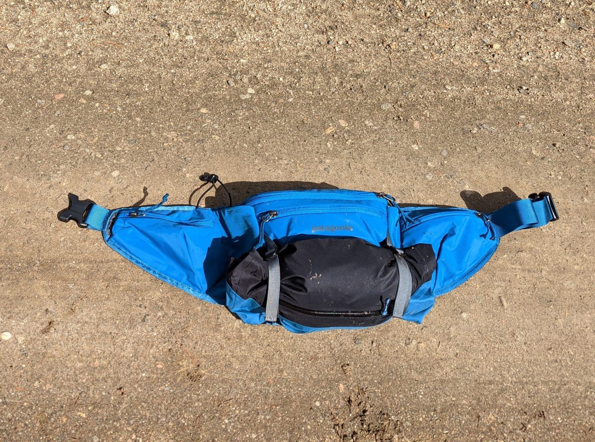 Patagonia Dirt Roamer waist pack with the Dirt Roamer Storm rain jacket neatly rolled up and carried on the outside. The slide buckles didn’t slip at all over a 20 mile ride; this is a great way to extend the utility of this pack to include extra layers in colder or wet weather.